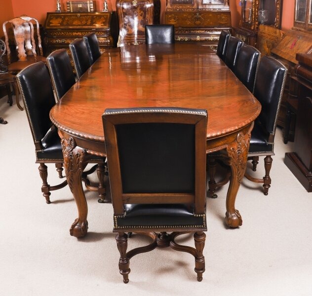 This antique Maple & Co burr walnut dining table, circa 1880, comes with ten French walnut chairs upholstered in Italian black leather with brass studs.